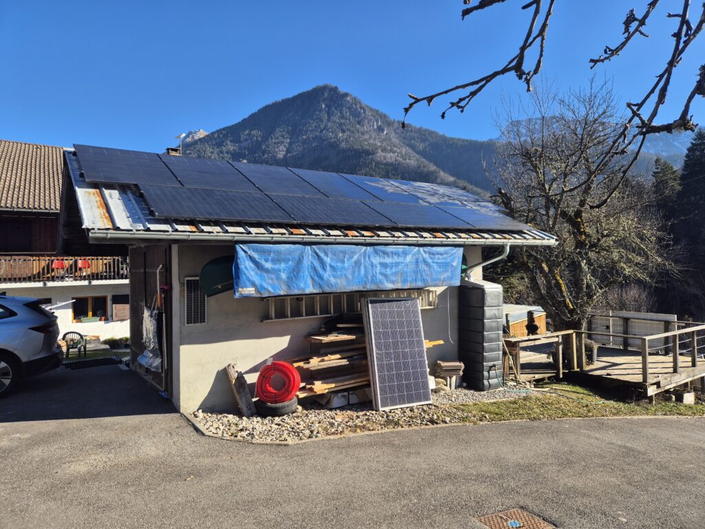 An image of solar pvs on a garage roof in the Alps